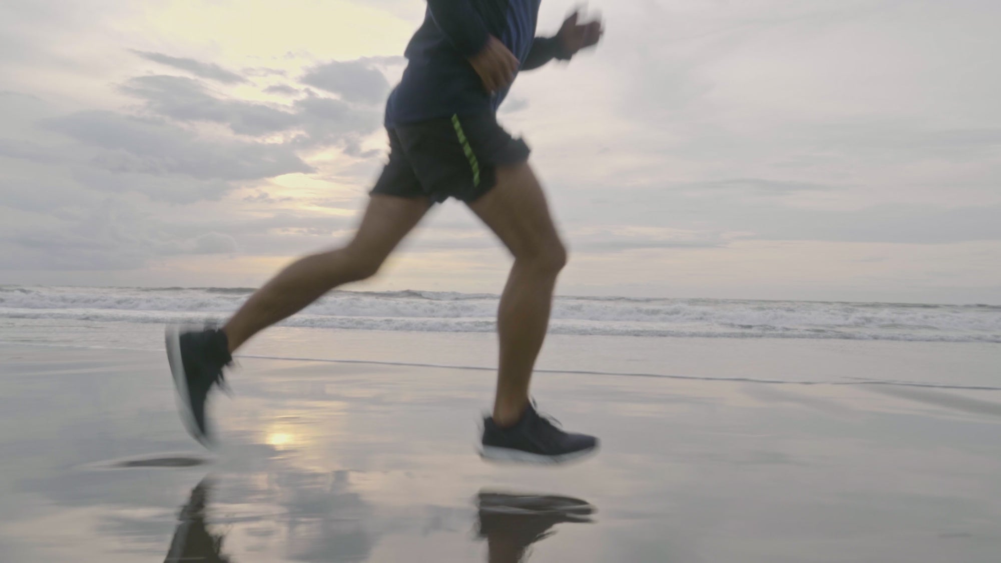 Ordinary man running at the beach at a fast pace